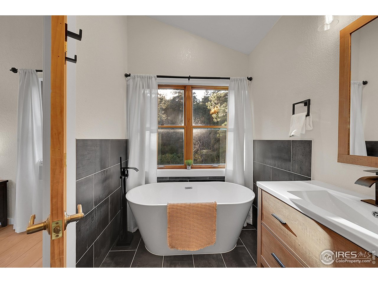 342 Brook Circle Boulder, CO 80302 - Photo 21 of 25 a bathroom with a sink a bathtub and a sink
