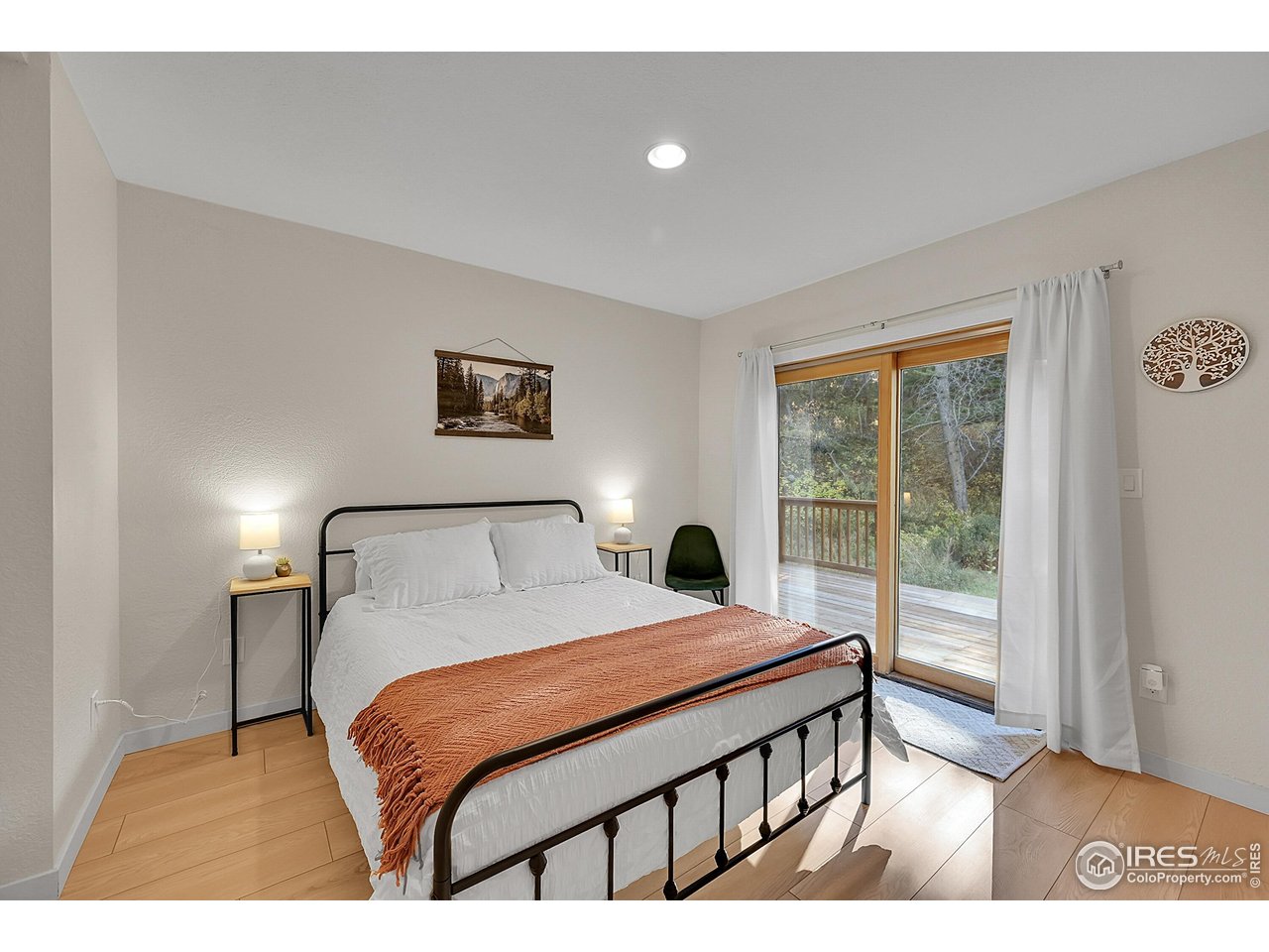 342 Brook Circle Boulder, CO 80302 - Photo 8 of 25 a bedroom with a bed a lamp and a large window