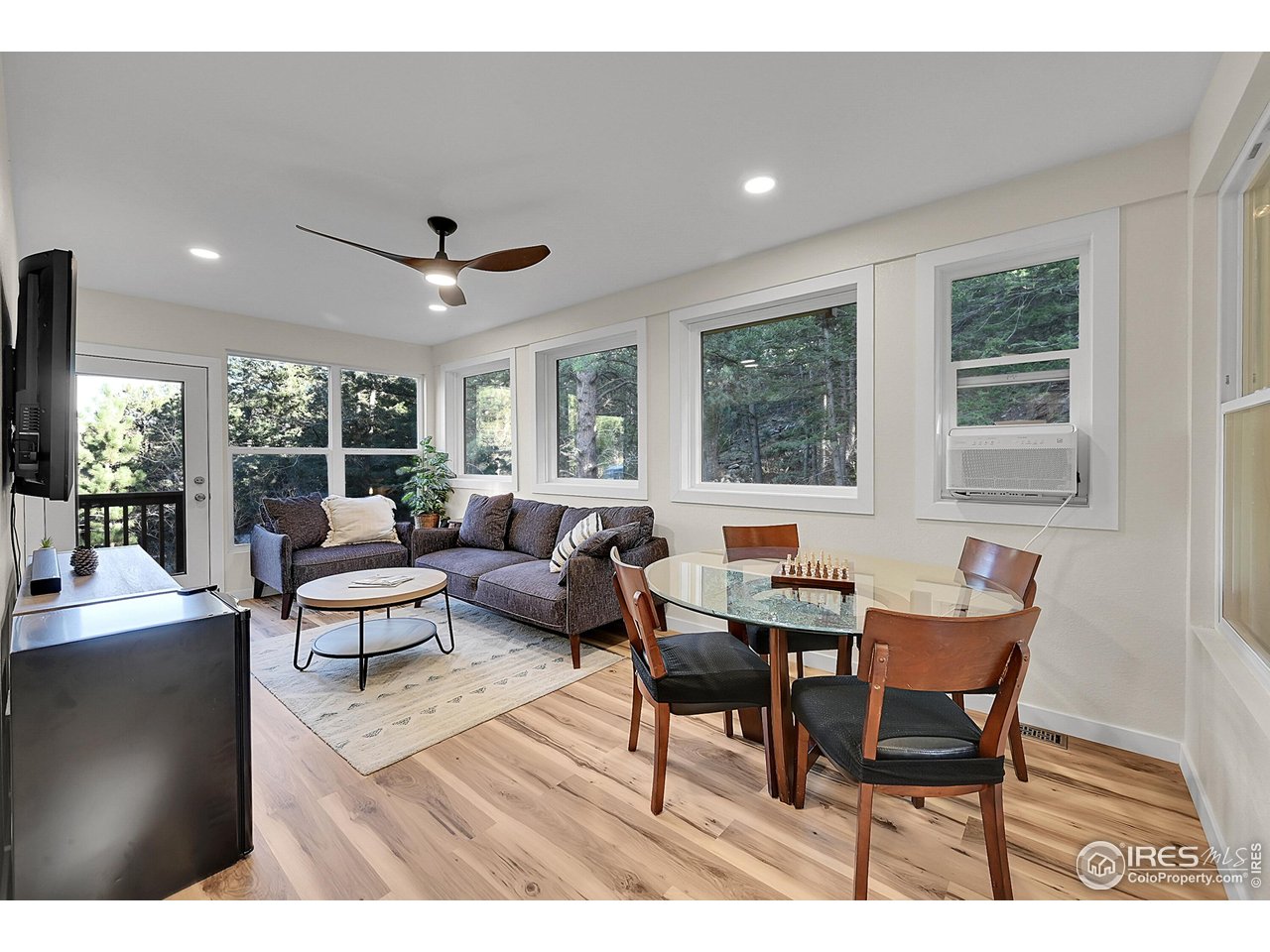 342 Brook Circle Boulder, CO 80302 - Photo 9 of 25 a living room with furniture a large window and wooden floor
