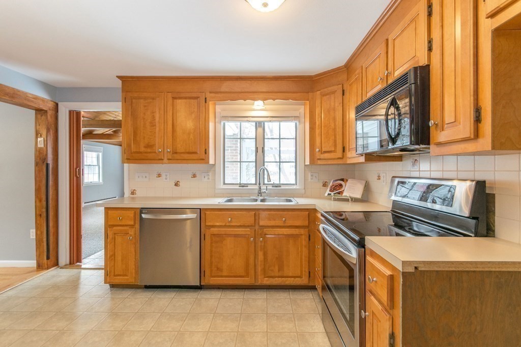 214 Captain Road Longmeadow, MA 01106 - Photo 11 of 29 a kitchen with stainless steel appliances granite countertop a stove a sink and a refrigerator