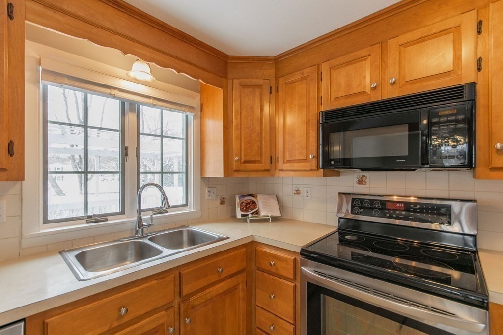 214 Captain Road Longmeadow, MA 01106 - Photo 12 of 29 a kitchen with a sink a microwave and cabinets