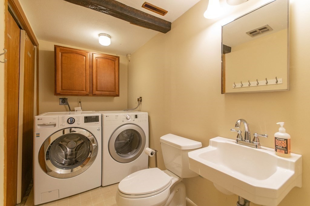 214 Captain Road Longmeadow, MA 01106 - Photo 23 of 29 a bathroom with a sink a toilet and mirror