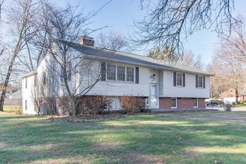 214 Captain Road Longmeadow, MA 01106 - Photo 3 of 29 a front view of house with yard and trees all around