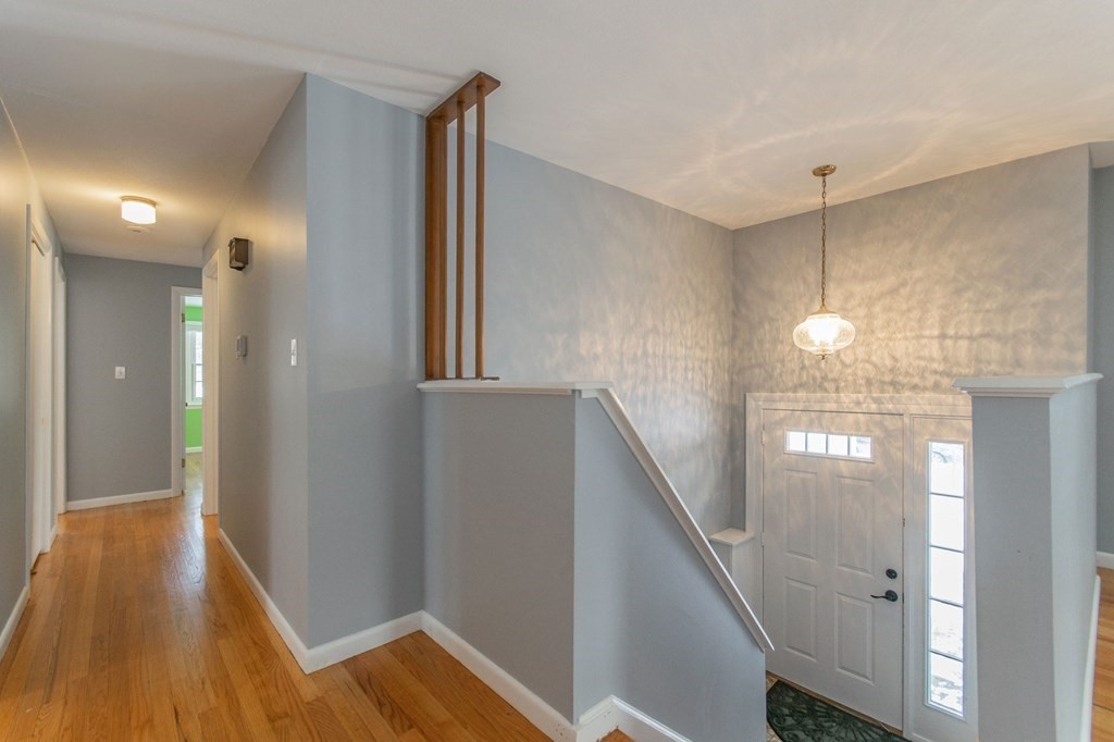 214 Captain Road Longmeadow, MA 01106 - Photo 5 of 29 a view of a hallway with wooden floor and staircase