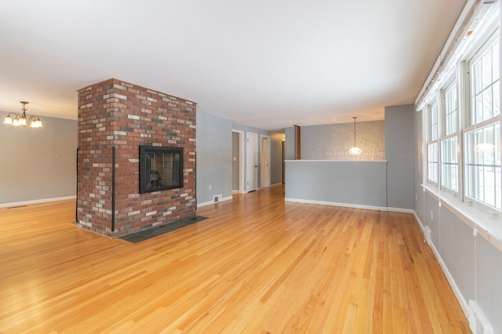 214 Captain Road Longmeadow, MA 01106 - Photo 8 of 29 a view of empty room with wooden floor and fireplace