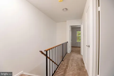 a view of a hallway with a door