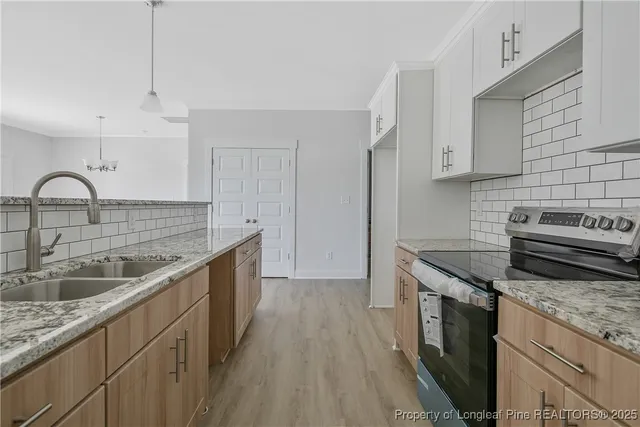 a bathroom with a granite countertop sink two mirror and a shower