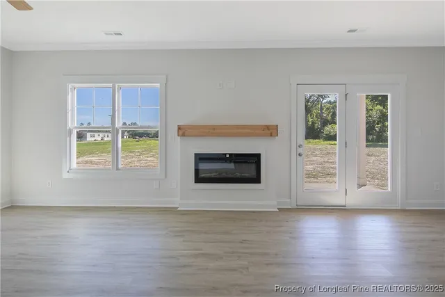 an empty room with window and wooden door