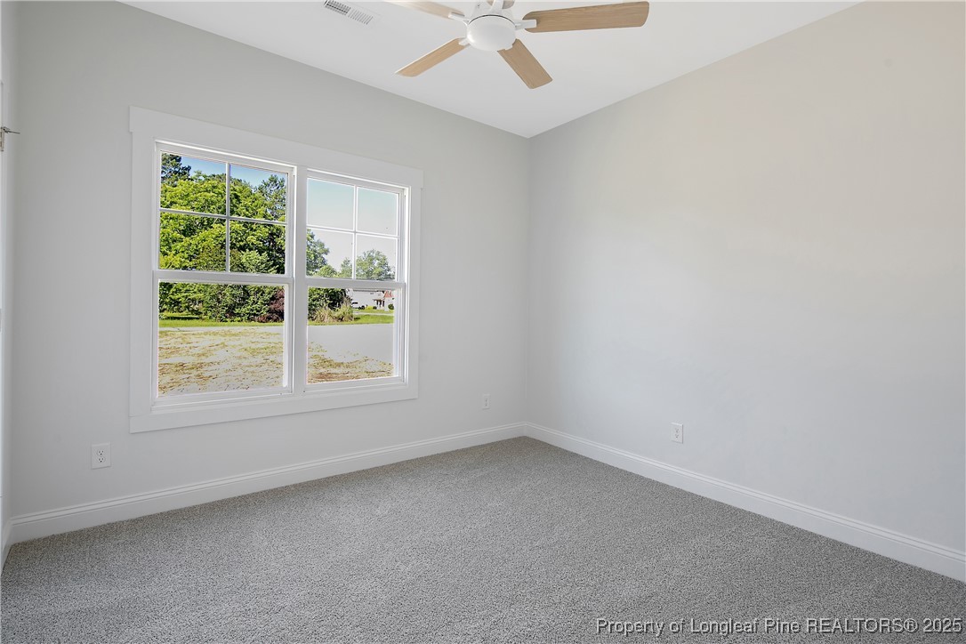 4905 High Branch Court Stedman, NC 28391 - Photo 31 of 47 an empty room with a window and a fan