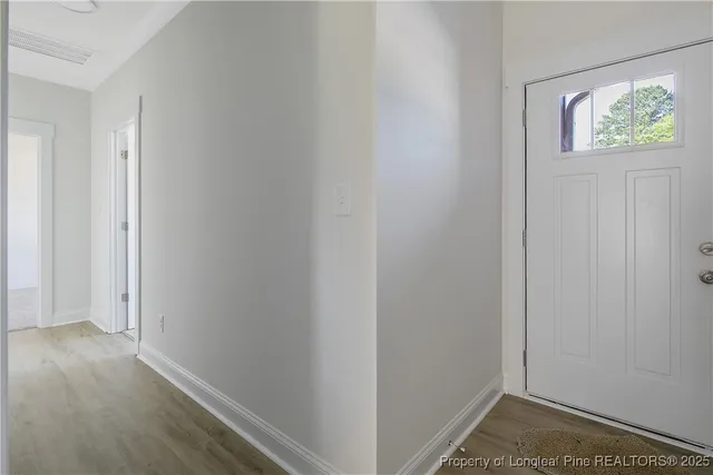 a view of a kitchen with wooden floors and a ceiling fan