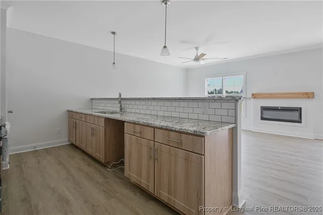 a view of a room with a ceiling fan