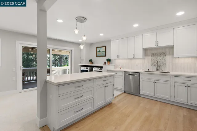 a kitchen with cabinets oven and a sink