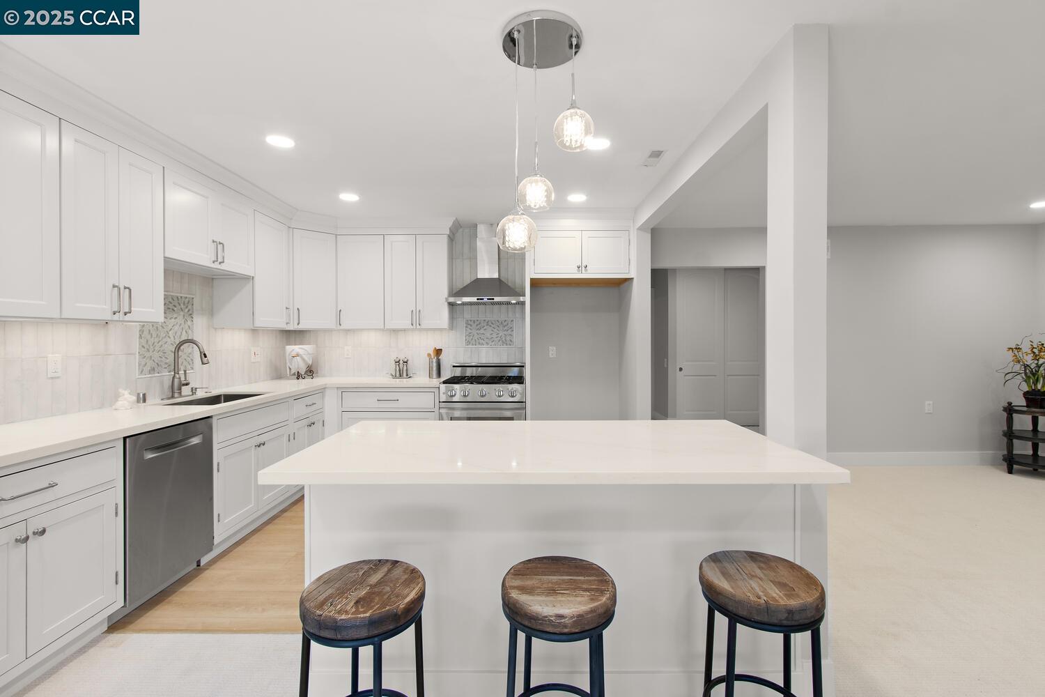 1132 Running Springs Road, Unit 11 Walnut Creek, CA 94595 - Photo 4 of 7 a kitchen with stainless steel appliances a table and chairs in it