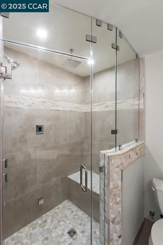 a bathroom with a shower a toilet and sink