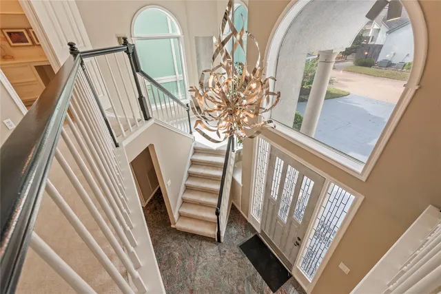 a big room with windows and fireplace