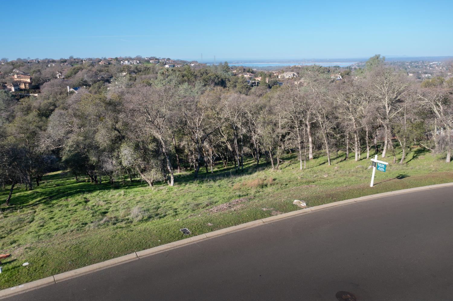 4095 Raphael Drive El Dorado Hills, CA 95762 - Photo 4 of 13 an aerial view of a house with a yard and lake view