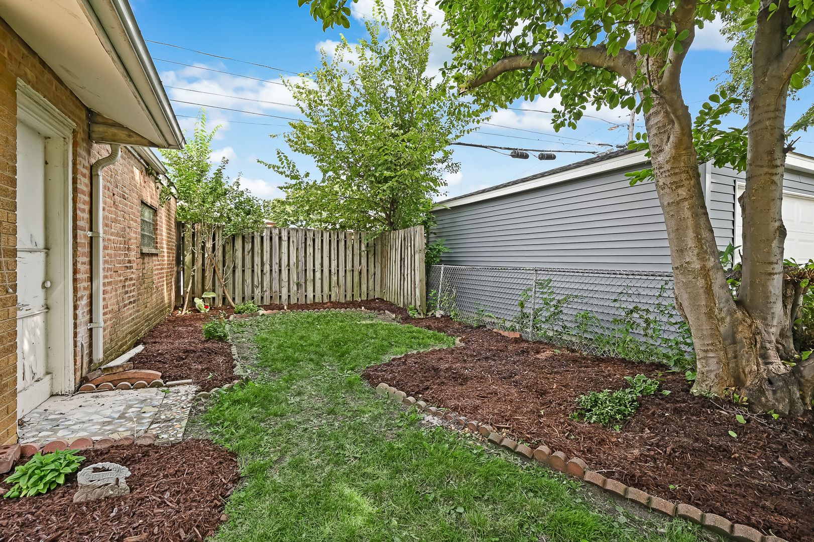 3852 West 80th Street Chicago, IL 60652 - Photo 19 of 19 a view of a house with a small yard and a large tree