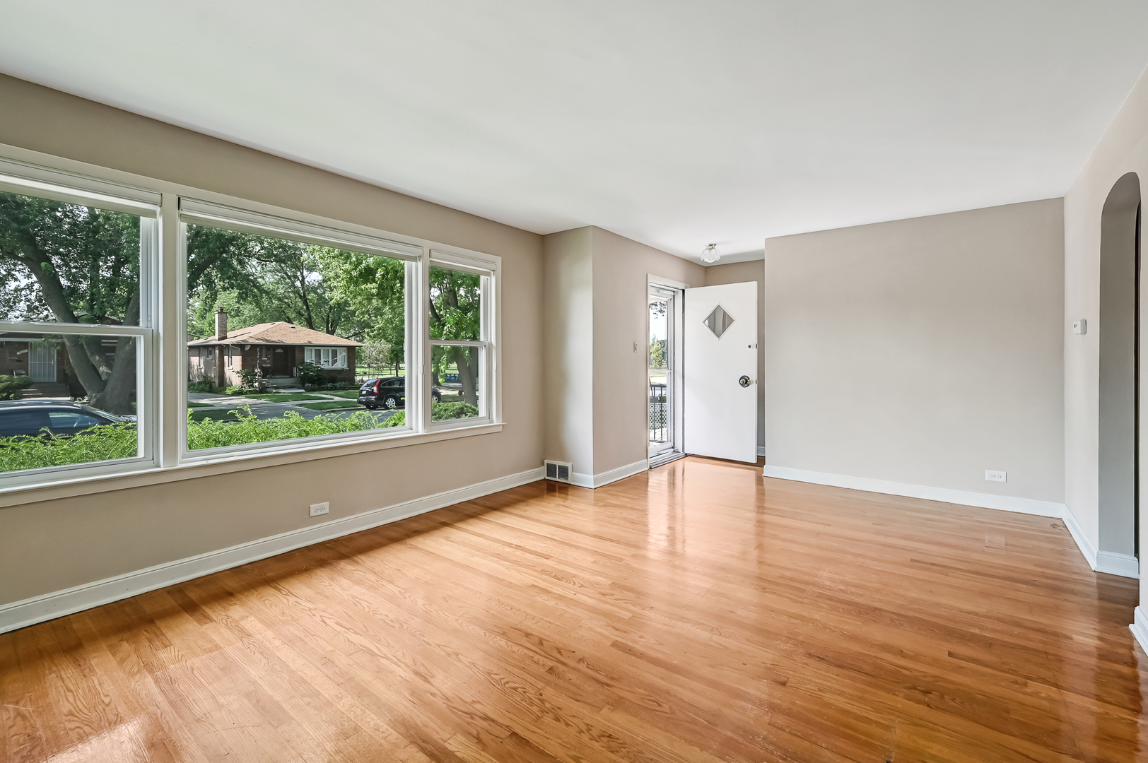 3852 West 80th Street Chicago, IL 60652 - Photo 4 of 19 a view of an empty room with wooden floor and a window
