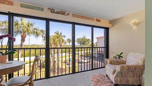 a balcony view with a water view and a large window