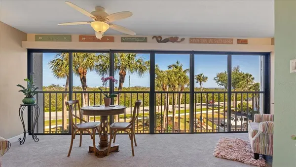 a view of a chairs and table in a balcony