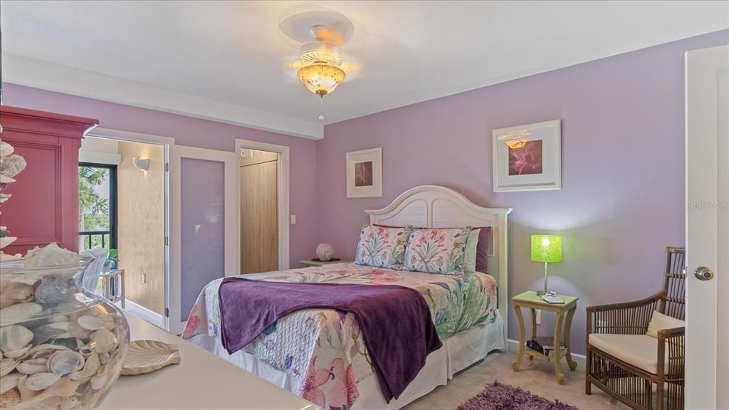 1701 Beach Road, Unit 312 Englewood, FL 34223 - Photo 18 of 39 a bedroom with a bed and a chandelier