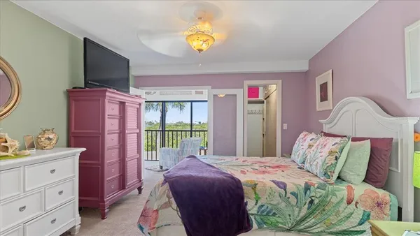 a bed room with a bed and a television