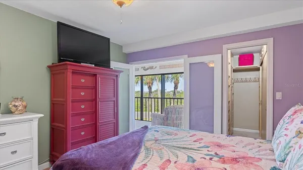a bedroom with a dresser and a television