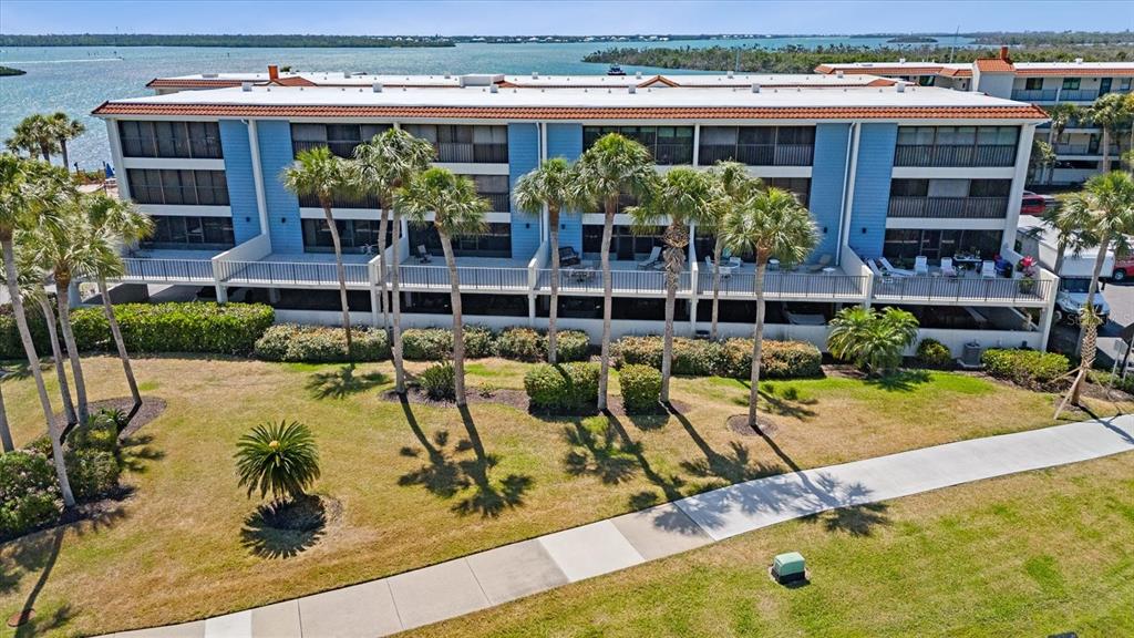 1701 Beach Road, Unit 312 Englewood, FL 34223 - Photo 2 of 39 a view of a swimming pool with outdoor seating
