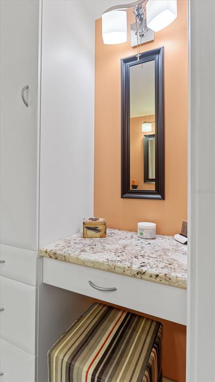 1701 Beach Road, Unit 312 Englewood, FL 34223 - Photo 27 of 39 a bathroom with a granite countertop sink and a mirror