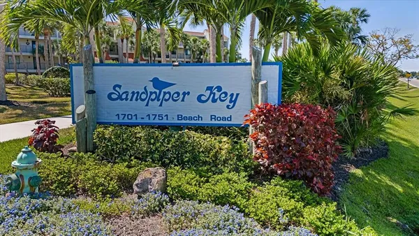 a sign that is in front of flowers