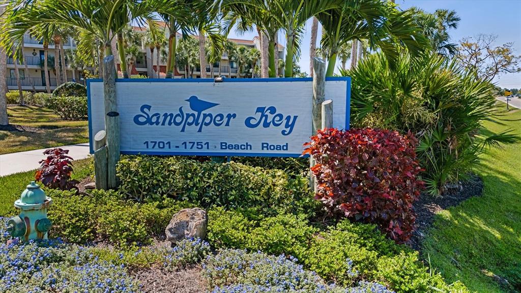 1701 Beach Road, Unit 312 Englewood, FL 34223 - Photo 3 of 39 a sign that is in front of flowers