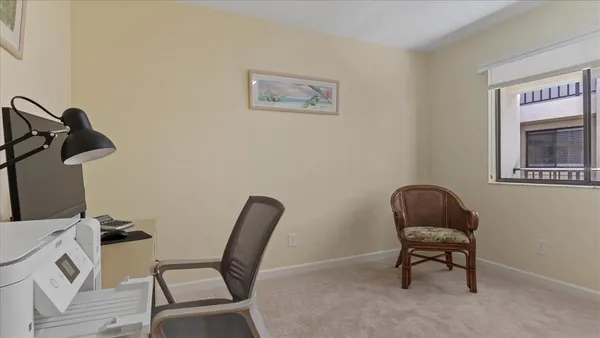 a view of a workspace with furniture and a flat screen tv