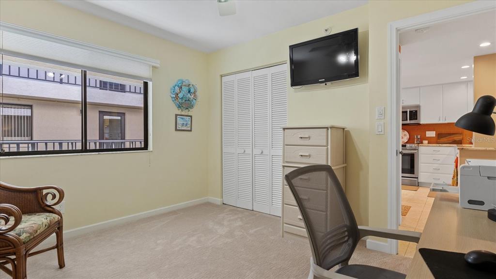 1701 Beach Road, Unit 312 Englewood, FL 34223 - Photo 32 of 39 a view of a workspace with furniture and a flat screen tv