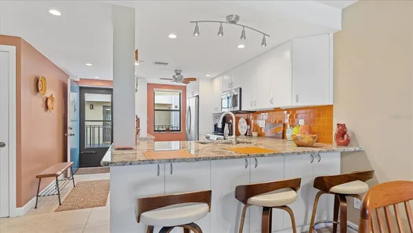 a kitchen with stainless steel appliances granite countertop breakfast area