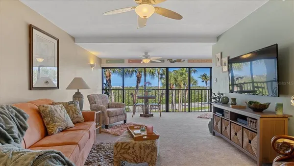 a living room with furniture and a floor to ceiling window