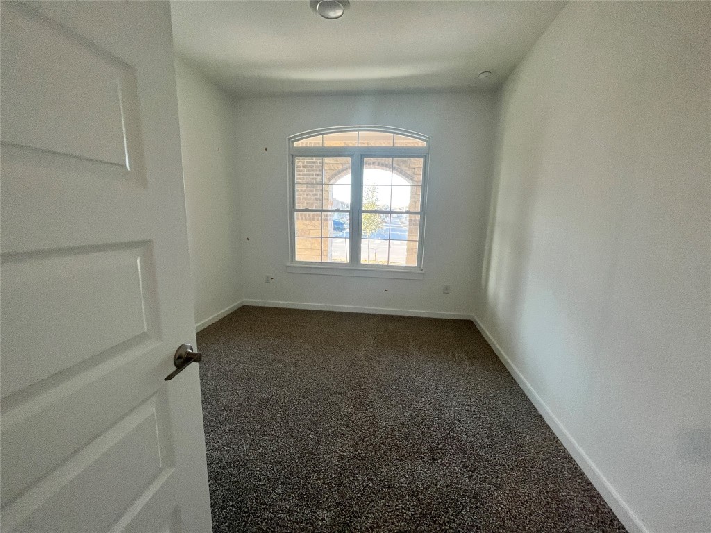 2012 Bobtail Pass Leander, TX 78641 - Photo 10 of 22 Spare room with dark colored carpet and baseboards