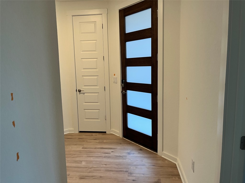 2012 Bobtail Pass Leander, TX 78641 - Photo 11 of 22 Entryway featuring light wood-style floors and baseboards
