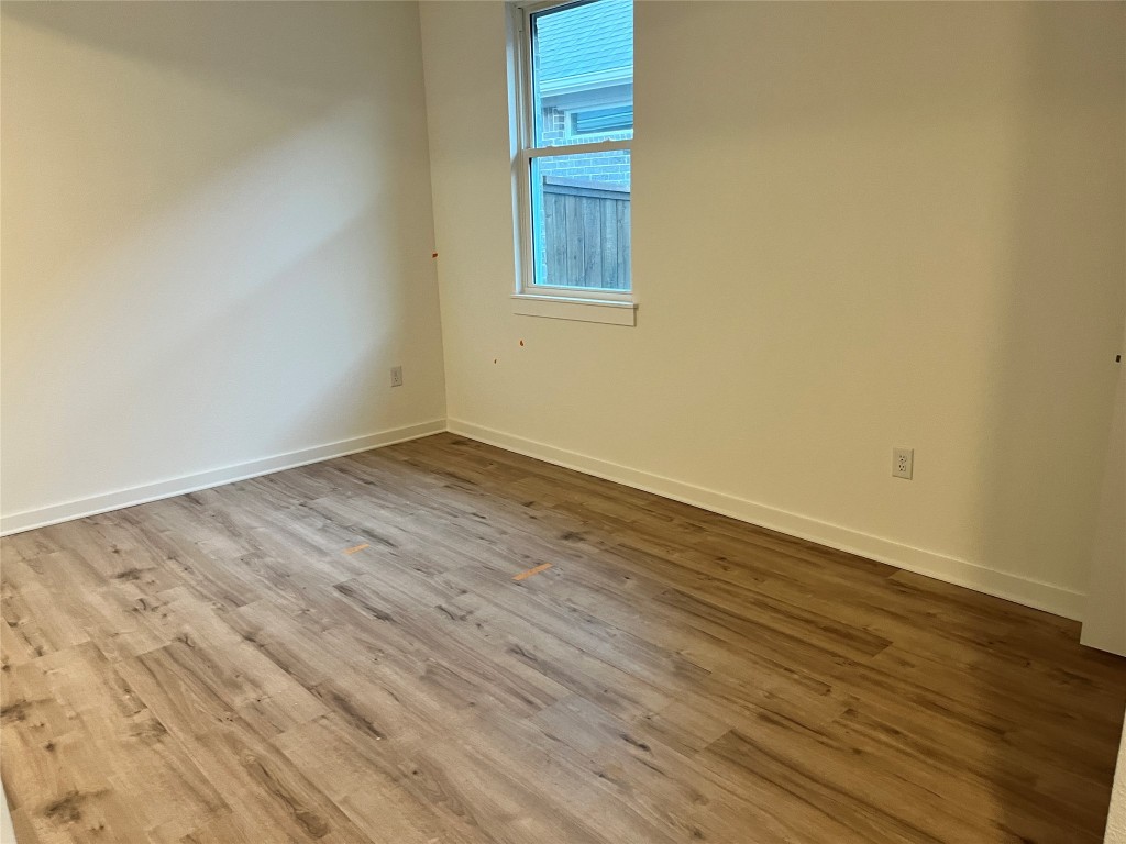 2012 Bobtail Pass Leander, TX 78641 - Photo 12 of 22 Empty room with wood finished floors and baseboards
