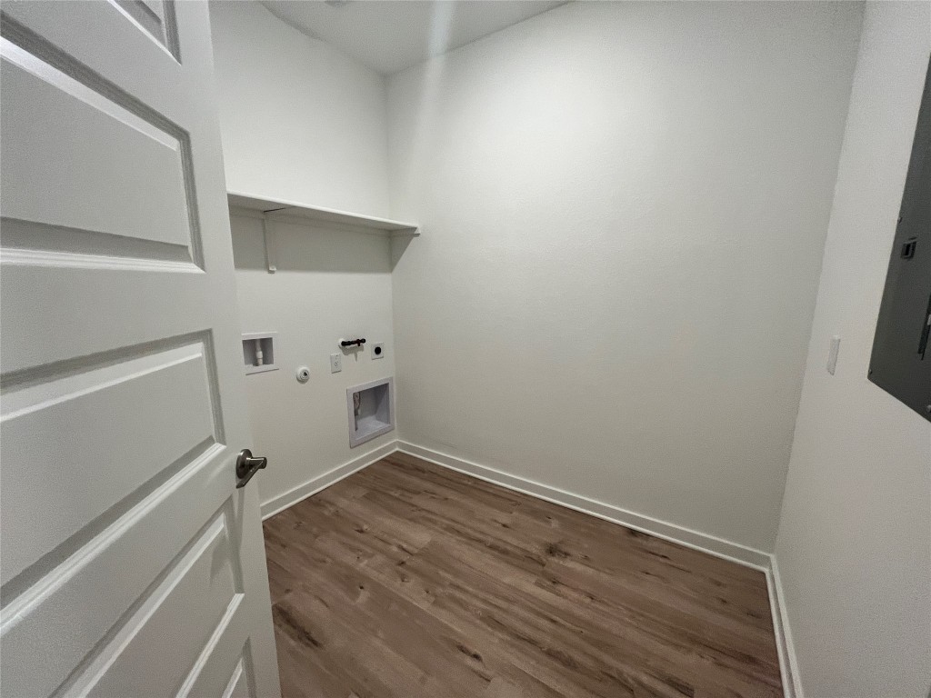 2012 Bobtail Pass Leander, TX 78641 - Photo 17 of 22 Washroom featuring gas dryer hookup, dark wood-type flooring, hookup for a washing machine, electric panel, and hookup for an electric dryer