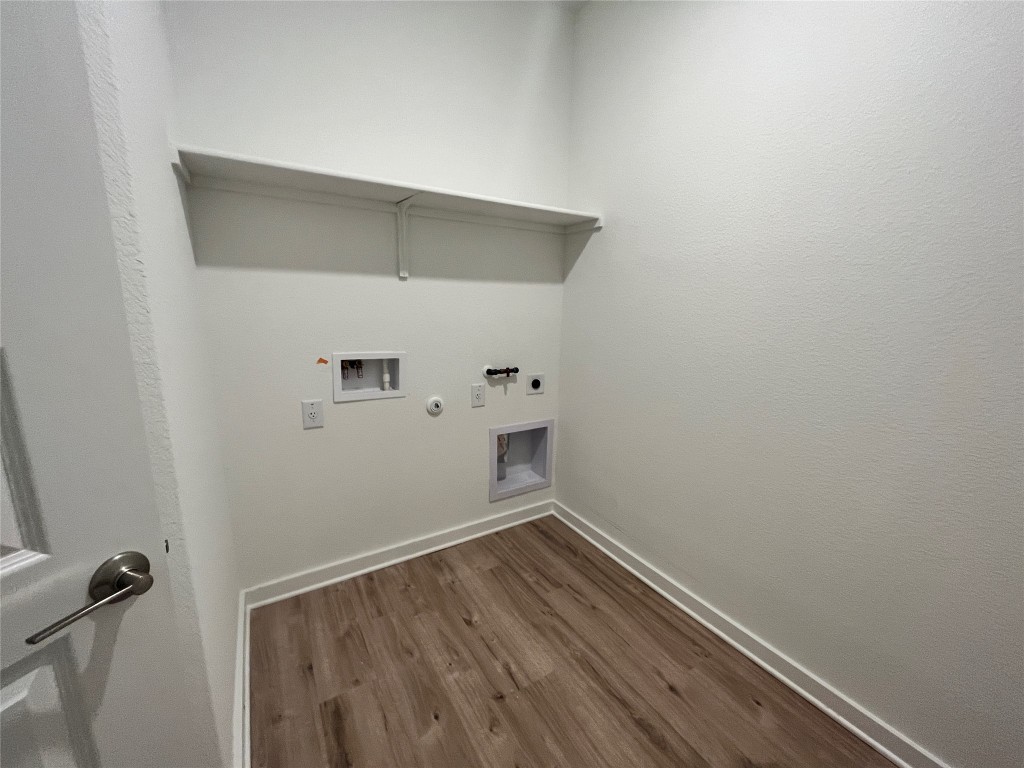 2012 Bobtail Pass Leander, TX 78641 - Photo 18 of 22 Washroom featuring gas dryer hookup, hookup for an electric dryer, dark wood-style flooring, and hookup for a washing machine