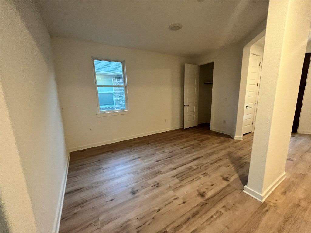 2012 Bobtail Pass Leander, TX 78641 - Photo 19 of 22 Unfurnished bedroom with light wood-style flooring