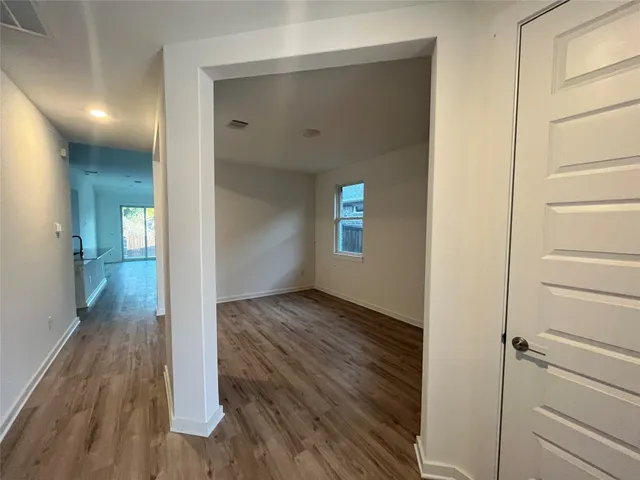 a view of hallway with wooden floor