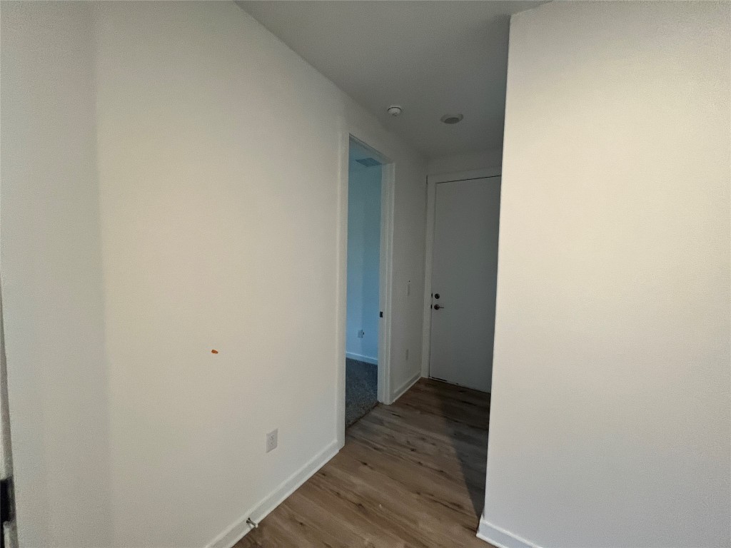 2012 Bobtail Pass Leander, TX 78641 - Photo 8 of 22 Hallway featuring baseboards and light wood-style floors