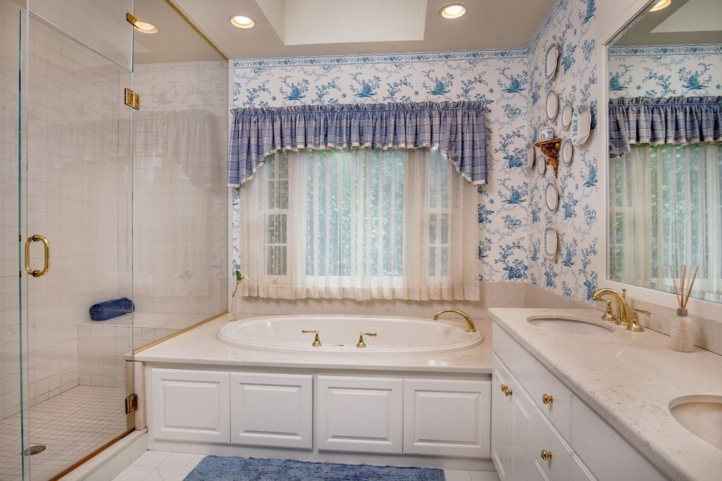 85 Dudley Road Newton, MA 02459 - Photo 13 of 32 a bathroom with a sink a mirror and a bathtub