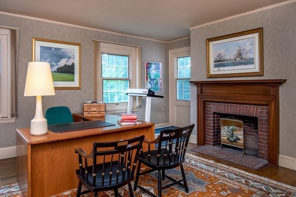 85 Dudley Road Newton, MA 02459 - Photo 16 of 32 a dining room with furniture and a fireplace