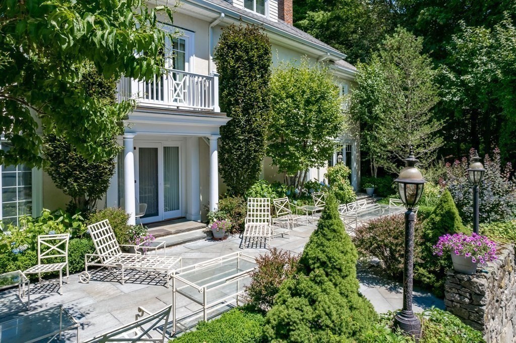 85 Dudley Road Newton, MA 02459 - Photo 25 of 32 a view of a house with potted plants and a fountain
