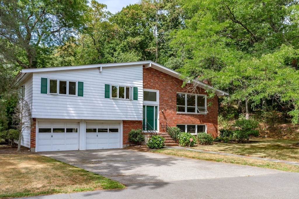 85 Dudley Road Newton, MA 02459 - Photo 27 of 32 a front view of a house with yard and trees in the background