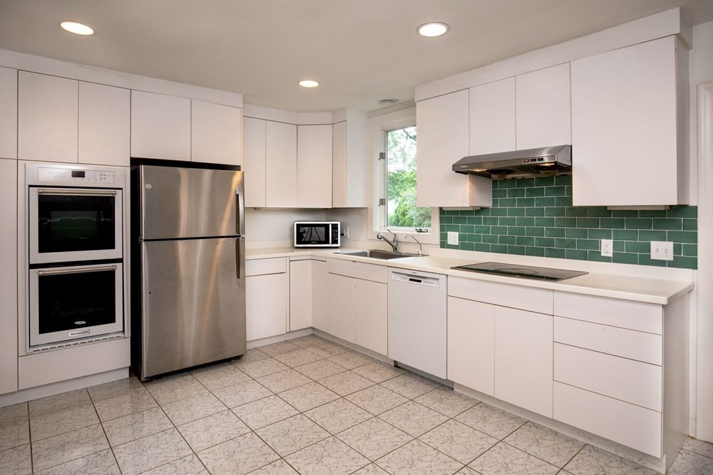 85 Dudley Road Newton, MA 02459 - Photo 29 of 32 a kitchen with white cabinets and refrigerator