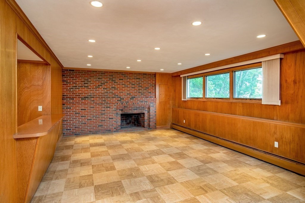 85 Dudley Road Newton, MA 02459 - Photo 31 of 32 a view of an empty room with a fireplace and a window