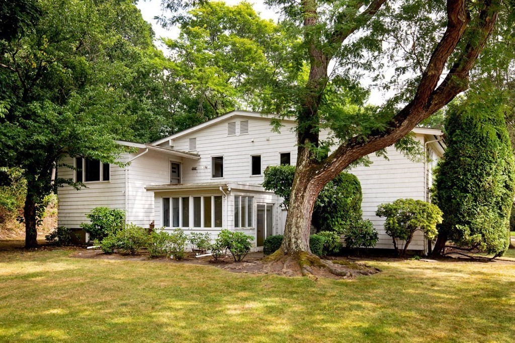 85 Dudley Road Newton, MA 02459 - Photo 32 of 32 a front view of a house with a yard garage and outdoor seating